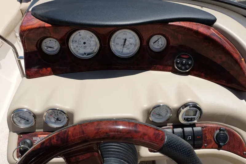 Slide: The Image of Dashboard of a 2006 Glastron GXL 205 boat with gauges and controls. - 25