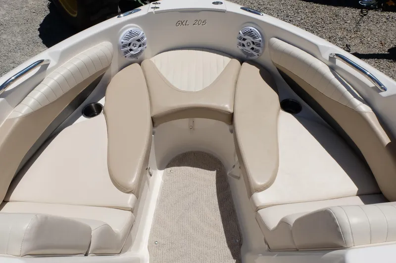 Slide: The Image of 2006 Glastron GXL 205 boat interior with beige seating and cup holders. - 4