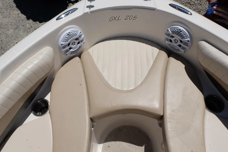 Slide: The Image of 2006 Glastron GXL 205 boat interior with beige seating and speakers. - 7