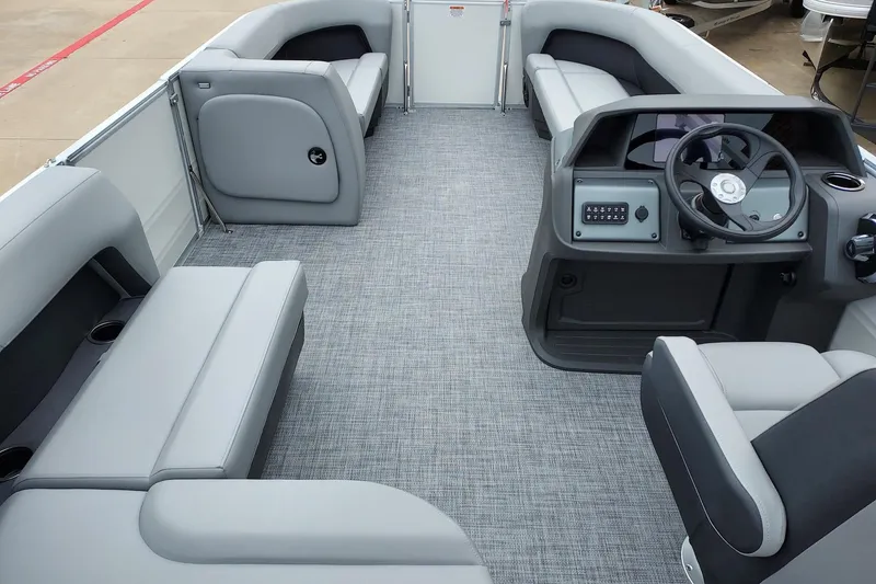 Slide: The Image of 2026 Sun Tracker Party Barge 18 DLX interior with gray seating and modern helm. - 4
