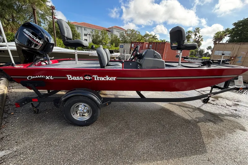 The Image of 2026 Tracker Bass Tracker Classic XL boat on trailer, red exterior, parked outdoors. - 0