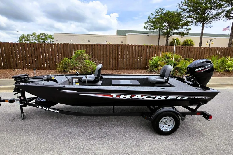 Slide: The Image of 2026 Tracker Panfish 17 boat with Mercury engine on trailer, parked outdoors. - 9