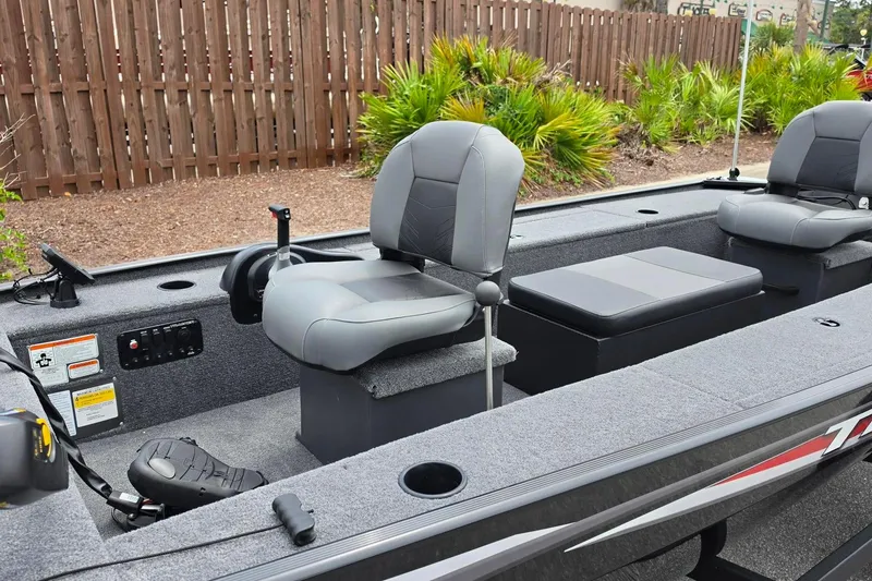 Slide: The Image of 2026 Tracker Panfish 17 boat interior with gray seating and control panel. - 12
