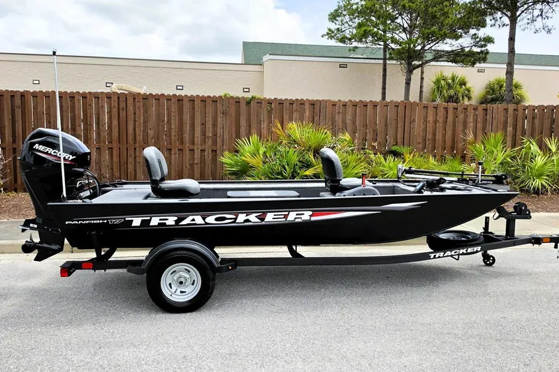 The Image of 2026 Tracker Panfish 17 boat on trailer, featuring Mercury outboard motor, parked outdoors. - 0