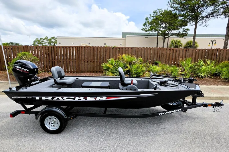 Slide: The Image of 2026 Tracker Panfish 17 boat with Mercury engine on trailer, parked outdoors. - 4
