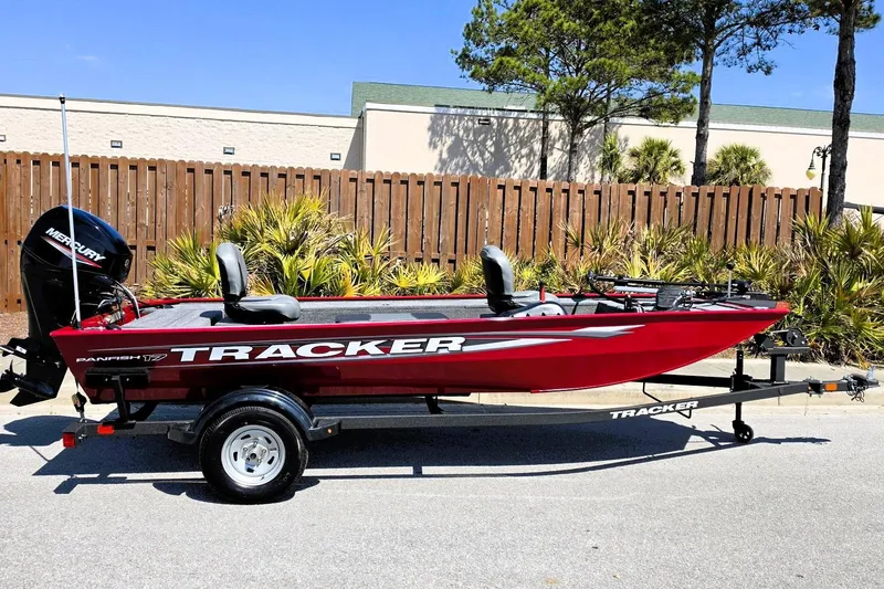 The Image of 2026 Tracker Panfish 17 boat, red, on trailer, parked outdoors. - 0