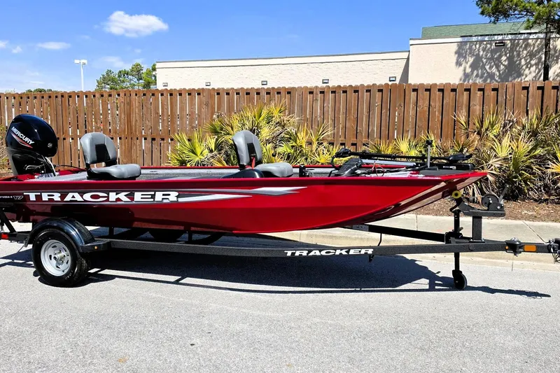 Slide: The Image of 2026 Tracker Panfish 17 boat on trailer, red exterior, parked outdoors. - 3