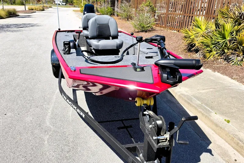 Slide: The Image of 2026 Tracker Panfish 17 boat on trailer, red exterior, dual seats, parked on street. - 6