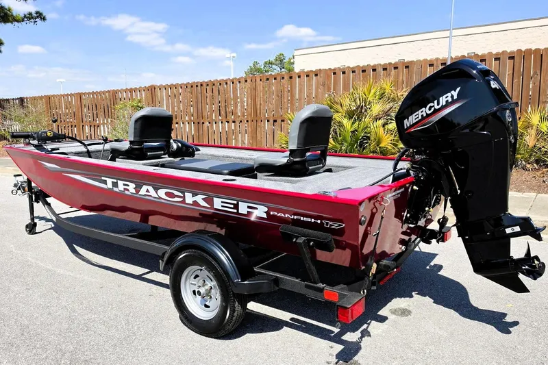Slide: The Image of 2026 Tracker Panfish 17 boat with Mercury engine, parked outdoors on a sunny day. - 7