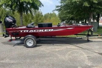 Slide: The Image of 2026 Tracker Panfish 17 boat on trailer, parked outdoors. - 2