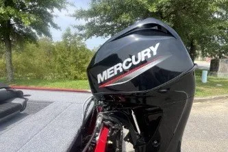 Slide: The Image of 2026 Tracker Panfish 17 boat with Mercury outboard motor, parked outdoors. - 4