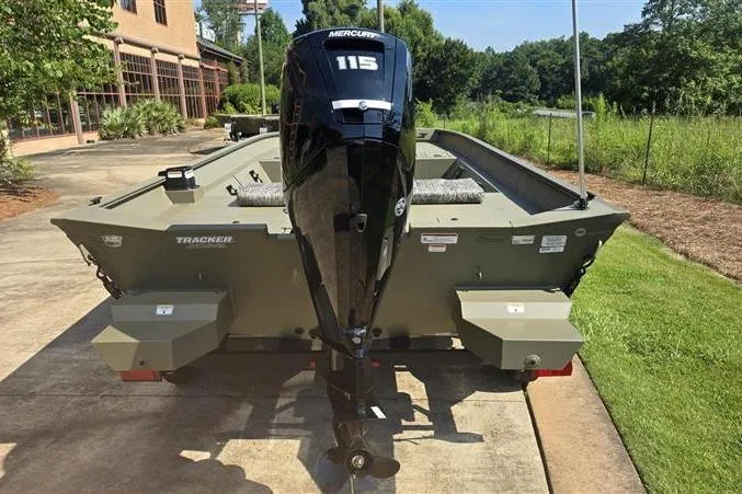 Slide: The Image of 2026 Tracker Grizzly 2072 CC boat with Mercury 115 engine, parked outdoors. - 7