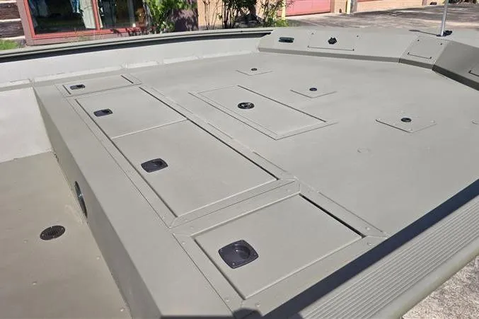 Slide: The Image of 2026 Tracker Grizzly 2072 CC boat deck with storage compartments. - 8