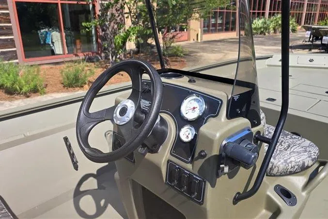 Slide: The Image of Steering console of 2026 Tracker Grizzly 2072 CC boat with gauges and controls. - 10