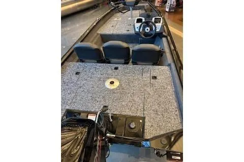 Slide: The Image of 2026 Tracker Pro Team 175 Crappie Edition boat interior with seating and steering console. - 2