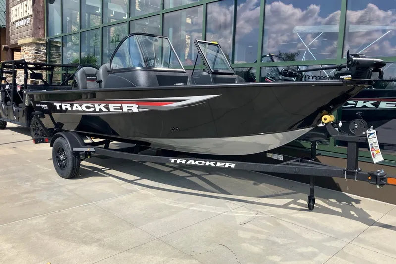 The Image of 2026 Tracker Pro Guide V-16 WT boat displayed outdoors on a trailer. - 0