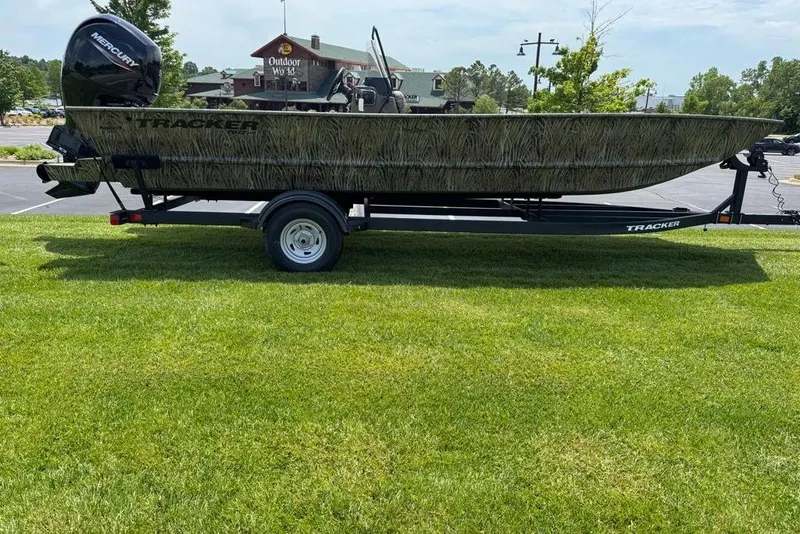 The Image of 2026 Tracker Grizzly 2072 CC boat on trailer, parked on grass near Outdoor World. - 0