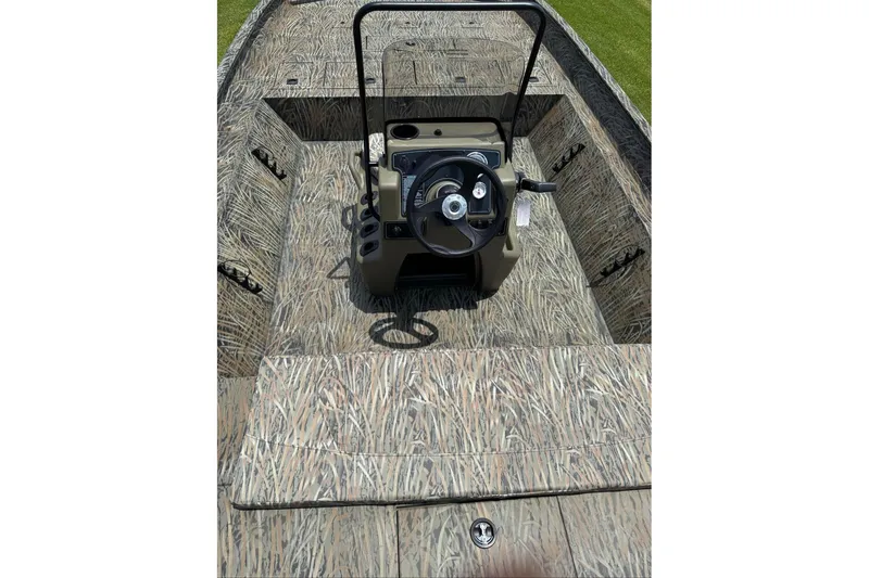 Slide: The Image of 2026 Tracker Grizzly 2072 CC boat interior with camo pattern and steering console. - 11