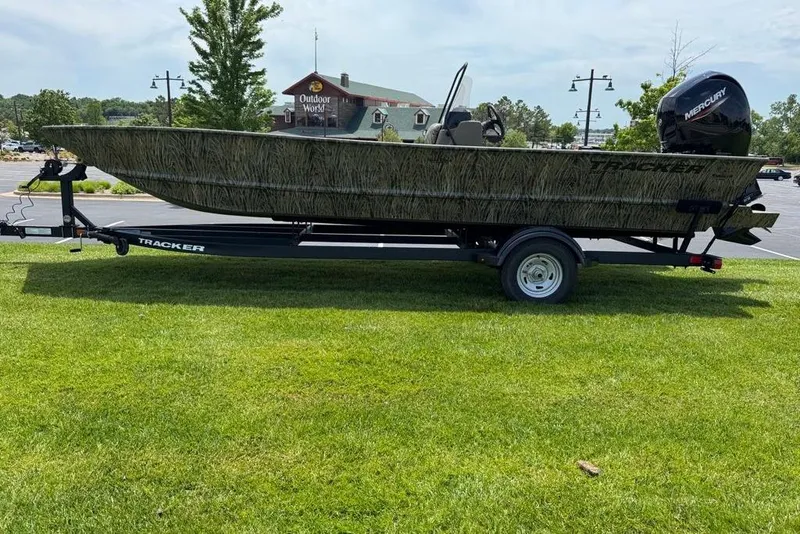 Slide: The Image of 2026 Tracker Grizzly 2072 CC boat on trailer, parked on grass near Outdoor World. - 3