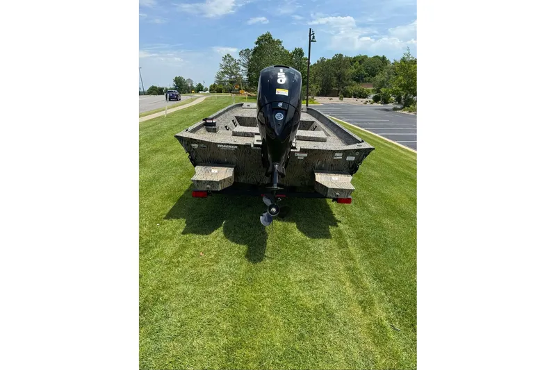 Slide: The Image of 2026 Tracker Grizzly 2072 CC boat on grass, rear view with outboard motor. - 5