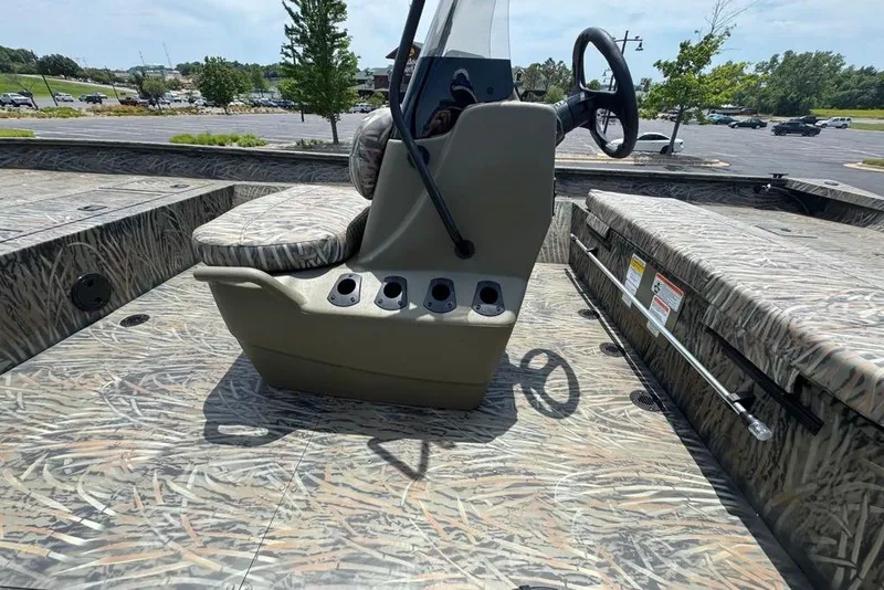 Slide: The Image of 2026 Tracker Grizzly 2072 CC boat interior with camouflage design and steering console. - 9