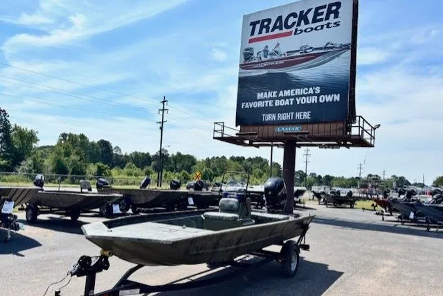 The Image of 2026 Tracker Grizzly 1860 CC boat displayed outdoors near a Tracker Boats billboard. - 0