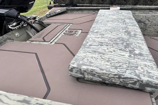 Slide: The Image of 2026 Tracker Grizzly 1860 CC boat interior with camouflage seating and deck design. - 11