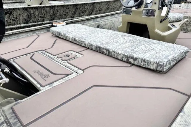 Slide: The Image of 2026 Tracker Grizzly 1860 CC boat interior with camo seating and control panel. - 12