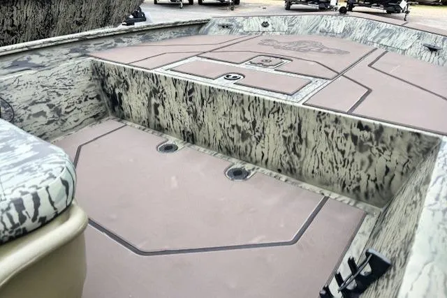 Slide: The Image of 2026 Tracker Grizzly 1860 CC boat interior with camouflage design and spacious deck layout. - 13