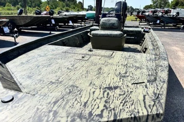 Slide: The Image of 2026 Tracker Grizzly 1860 CC boat with camouflage design, displayed outdoors. - 15