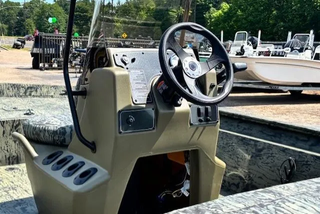 Slide: The Image of 2026 Tracker Grizzly 1860 CC boat console with steering wheel and controls. - 18