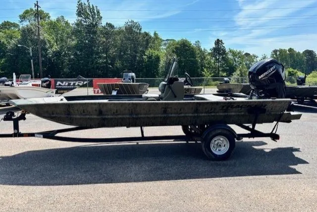 Slide: The Image of 2026 Tracker Grizzly 1860 CC boat on trailer, parked outdoors. - 2