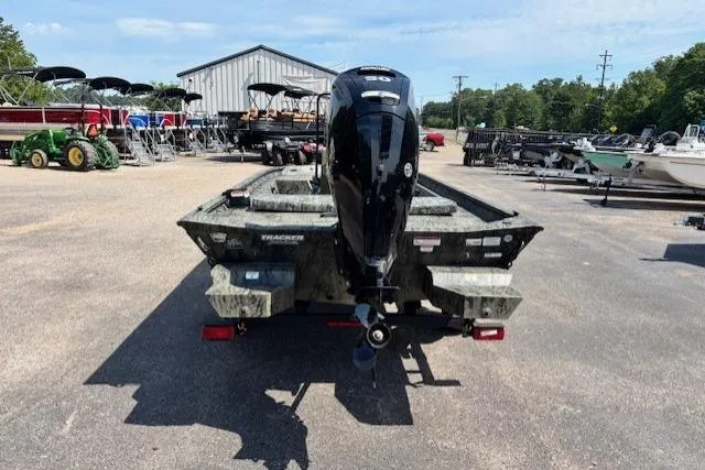 Slide: The Image of 2026 Tracker Grizzly 1860 CC boat with outboard motor in a dealership lot. - 4
