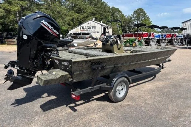 Slide: The Image of 2026 Tracker Grizzly 1860 CC boat with Mercury engine on trailer, outdoors. - 5