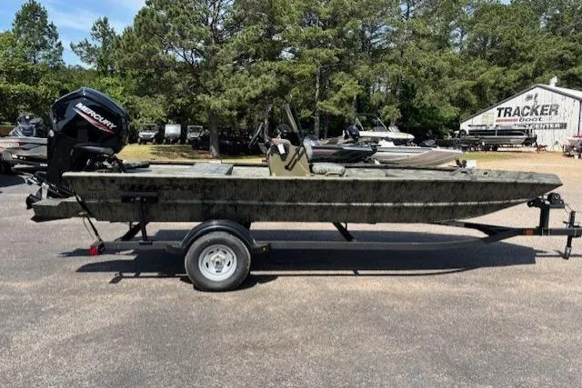 Slide: The Image of 2026 Tracker Grizzly 1860 CC boat on trailer, parked outdoors. - 6