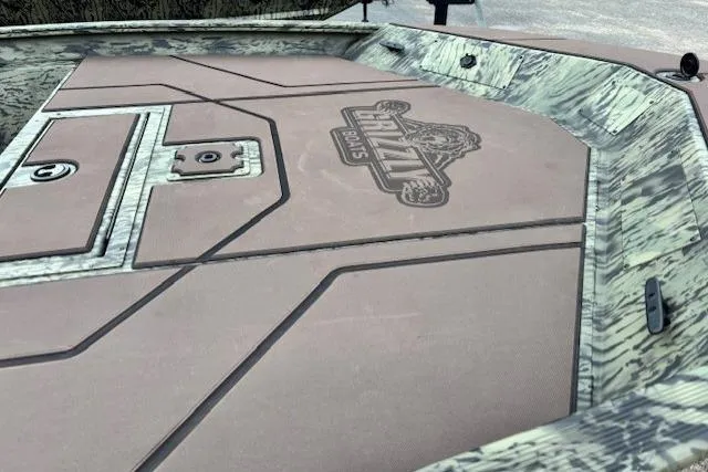 Slide: The Image of 2026 Tracker Grizzly 1860 CC boat deck with camo design and logo detailing. - 8