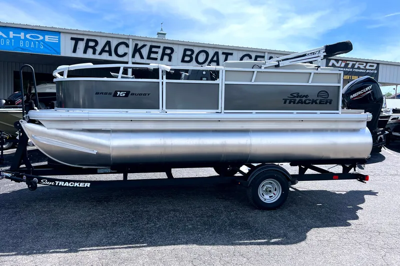 The Image of 2026 Sun Tracker Bass Buggy 16 XL Select pontoon boat on trailer at dealership. - 0