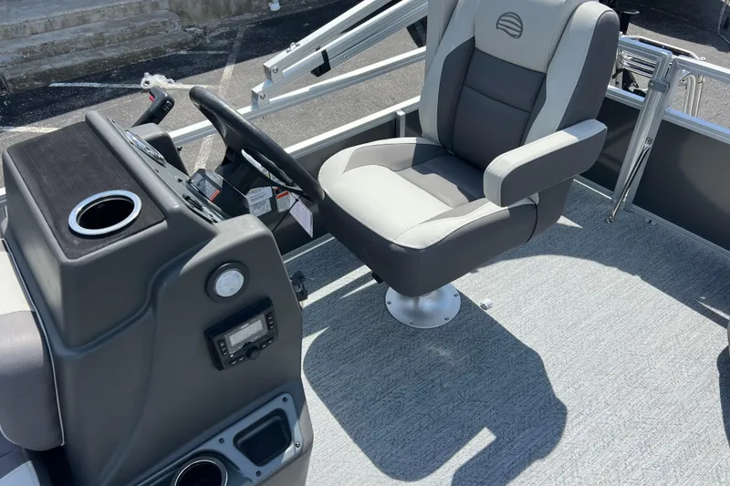 Slide: The Image of 2026 Sun Tracker Bass Buggy 16 XL Select boat interior with captain's chair and steering console. - 6