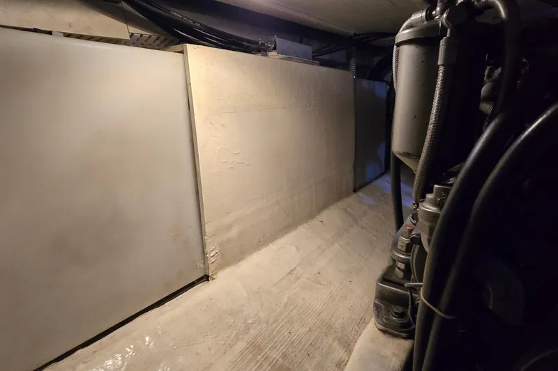 Slide: The Image of Engine room of a 2004 Sabre 36 boat, featuring mechanical components and wiring. - 60