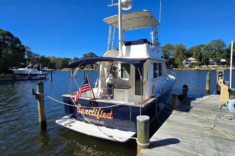 Slide: The Image of 2004 Sabre 36 yacht docked in Annapolis, MD, with American flag displayed. - 13