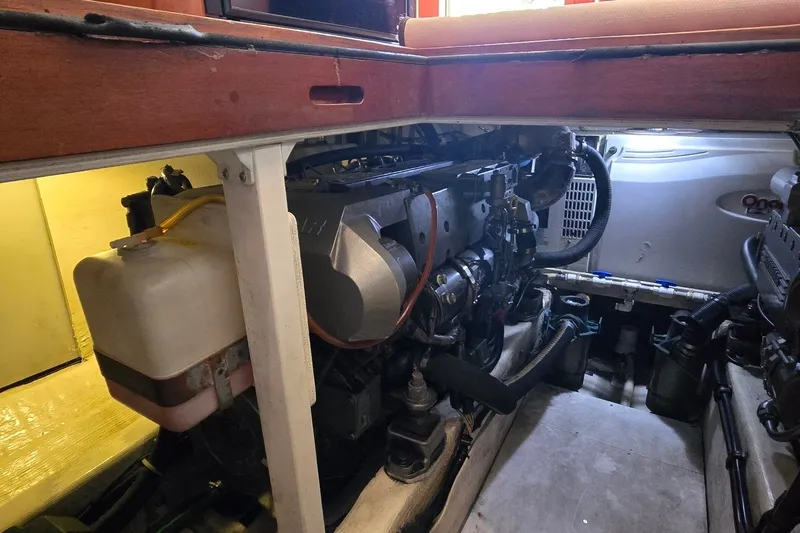 Slide: The Image of Engine compartment of a 2004 Sabre 36 boat, showcasing mechanical components and storage. - 58