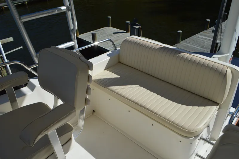 Slide: The Image of 2004 Sabre 36 boat interior with beige seating and dock view. - 22