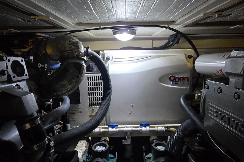 Slide: The Image of Engine room of a 2004 Sabre 36 boat featuring an Onan generator. - 62