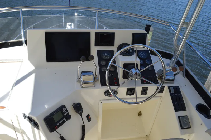 Slide: The Image of Helm of 2004 Sabre 36 boat with steering wheel and navigation controls. - 18