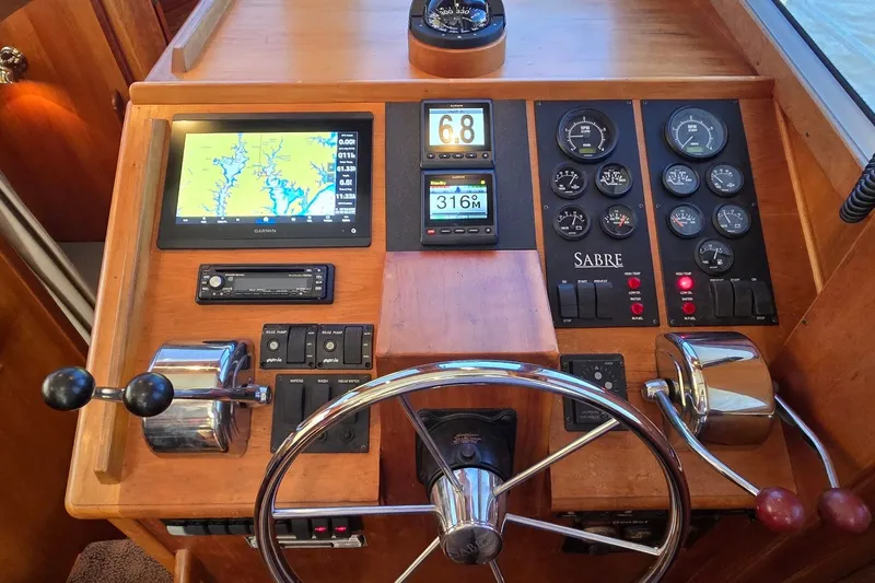 Slide: The Image of Control panel of a 2004 Sabre 36 boat with navigation and gauges. - 33