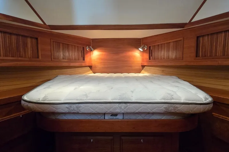 Slide: The Image of Cozy cabin interior of 2004 Sabre 36 yacht with a comfortable bed and warm lighting. - 39