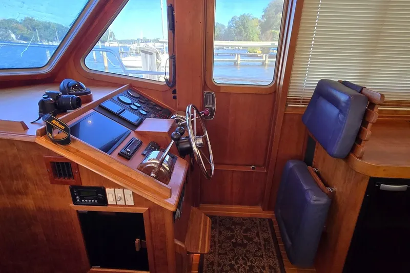Slide: The Image of Interior helm of 2004 Sabre 36 boat with wooden finish and navigation equipment. - 31