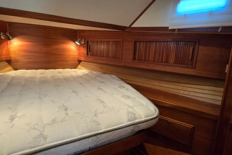Slide: The Image of Cozy cabin interior of 2004 Sabre 36 yacht with wooden accents and comfortable bedding. - 41