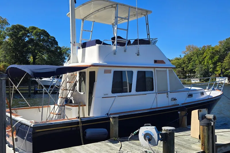 Slide: The Image of 2004 Sabre 36 yacht docked at marina, featuring flybridge and canopy. - 6