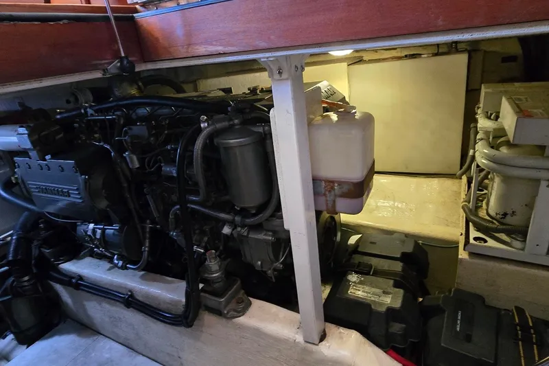 Slide: The Image of Engine compartment of a 2004 Sabre 36 boat, showcasing mechanical components and storage area. - 55